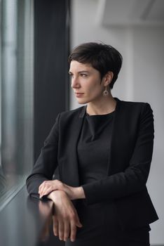 Portrait Of Successful Businesswoman by the window Entrepreneur At Busy startup Office