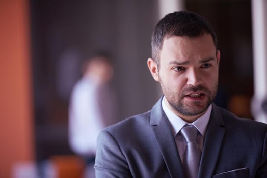 happy young business man portrait  at modern meeting office indoors