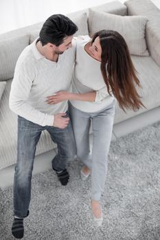 laughing couple having fun on the couch in the living room.the concept of happiness