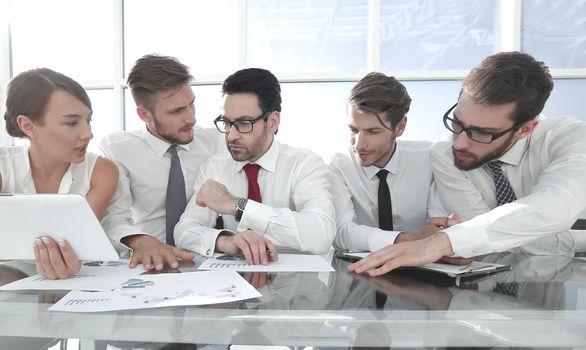 business team using a digital tablet to work with financial data.business concept
