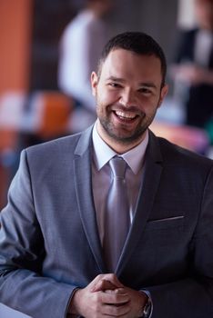 happy young business man portrait  at modern meeting office indoors