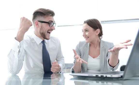 happy business couple sitting at their Desk.success concept