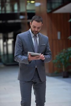 portrait of young business man with tablet computer at modern office