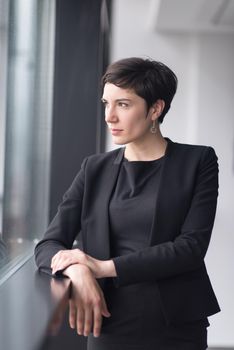 Portrait Of Successful Businesswoman by the window Entrepreneur At Busy startup Office