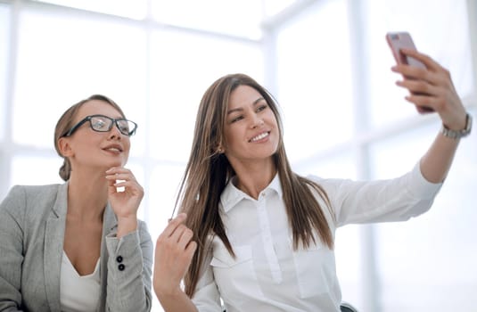 young employees take selfies in the workplace.photo with text space