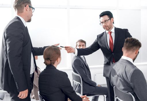 Business man giving a pen to a businessman for signing a contract