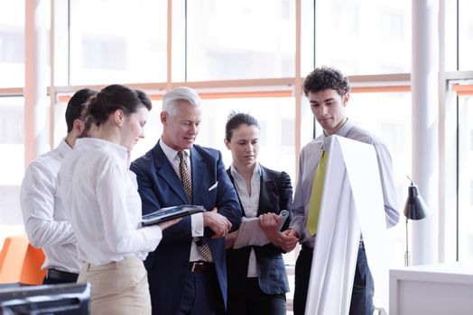 young startup businessman making presentation of project to senior investior, group of business people taking notes and make plans on white  flip board and tablet computer
