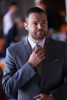 happy young business man portrait  at modern meeting office indoors