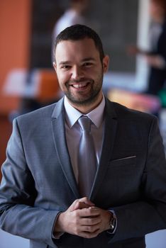 happy young business man portrait  at modern meeting office indoors