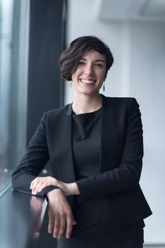 Portrait Of Successful Businesswoman by the window Entrepreneur At Busy startup Office