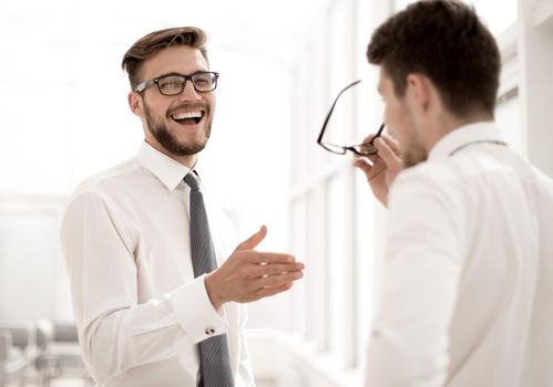 close up. employees talk, standing in a spacious office.business concept