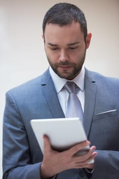 portrait of young business man with tablet computer at modern office