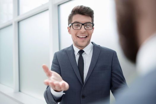 young businessman talking standing in the office.business concept