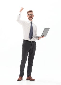 in full growth. happy businessman holding open laptop.photo with copy space