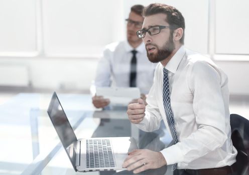 thoughtful employee sitting at the office Desk.business concept