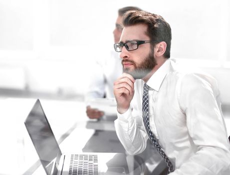 dreaming employee sitting at the office Desk.business concept