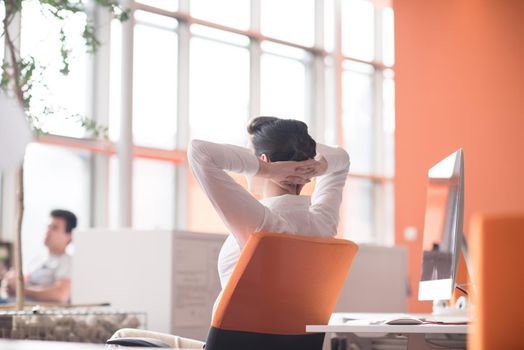 happy young business woman relaxing and geting insiration while working on desktop computer at modern bright  starup office interior