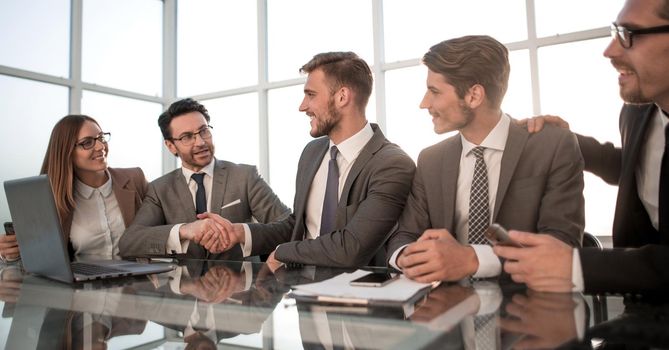 stock traders analyzing market, pointing at charts on monitor.