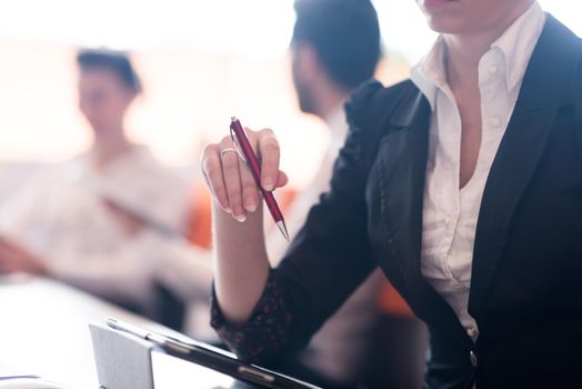 close-up of woman hands holding pen on business meeting