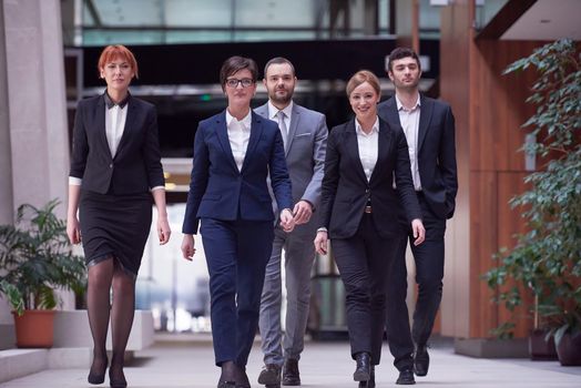 young business people team walking, group of people on modern office hall interior