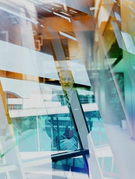 Double exposure design. Portrait of senior business man with grey beard and hair alone i modern office indoors