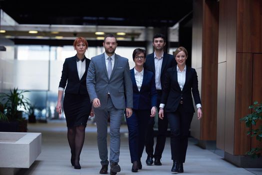 young business people team walking, group of people on modern office hall interior