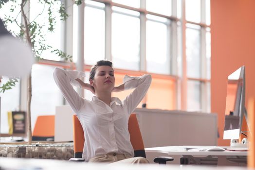 happy young business woman relaxing and geting insiration while working on desktop computer at modern bright  starup office interior