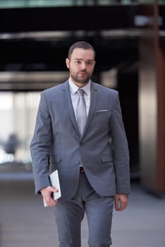 portrait of young business man with tablet computer at modern office