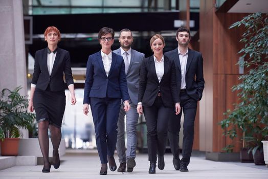 young business people team walking, group of people on modern office hall interior