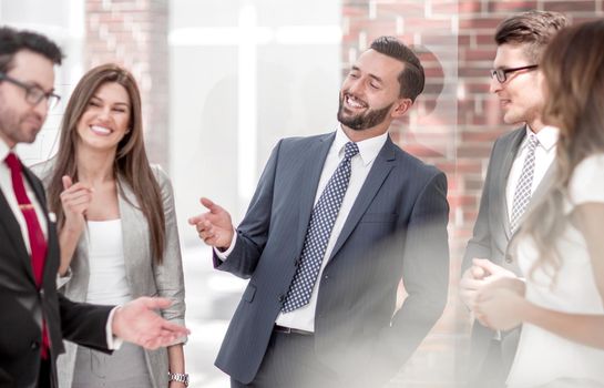 smiling staff discussing something in the office hallway.the concept of communication