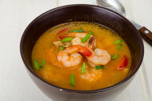 Spicy thai shrimp soup on plate. Studio Photo