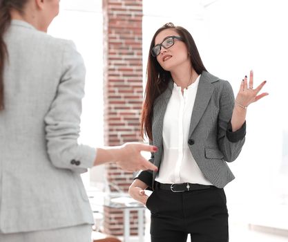 Manager talking with a client standing in the office .the concept of communication