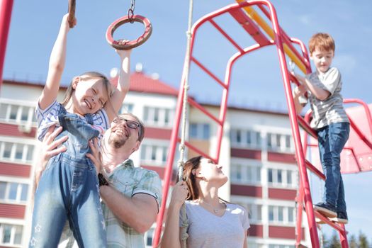 young family with children playing in the Playground.the concept of childhood and parenting