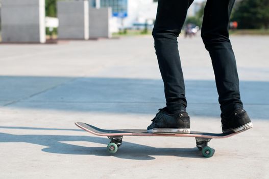 young skater perfoming stunt on his blue board