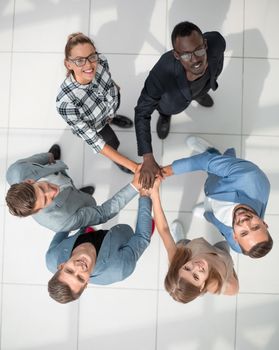 Its a dream team! Top high angle view Full length body, size and high angle view portrait of carefree, trandy hipster folded hands stacked on top of each other in the end of a successful teamwork