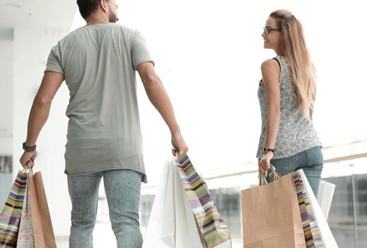 rear view.young family with shopping bags.photo with copy space