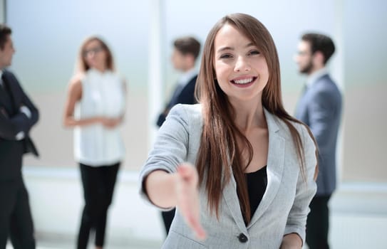 successful businesswoman holding out her hand for a handshake.concept of partnership