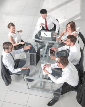 High angle view of multi-ethnic business people discussing in board room meeting