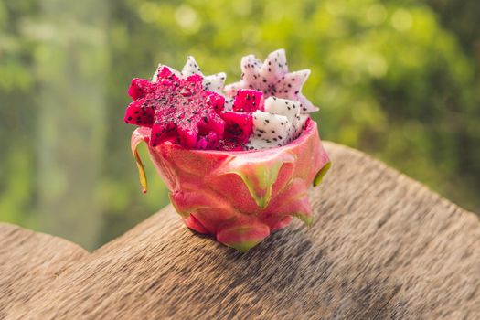 Pieces of sliced dragon fruit in the form of a star on an old withered background.