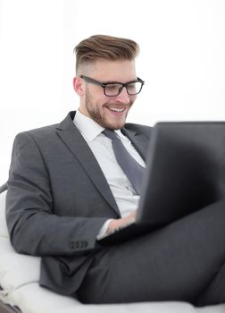 close up.businessman using laptop sitting in chair. photo with text space