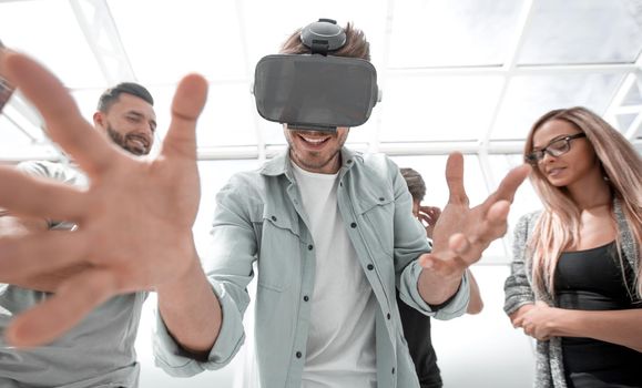 man using Virtual Reality and laughing with arms stretched