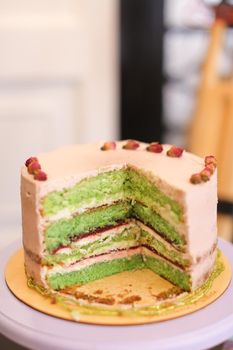 Yummy green multicolored cake. Concept of sweet food for birthday party.