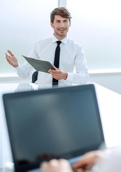 businessman with a clipboard sitting at the negotiating table.business concept