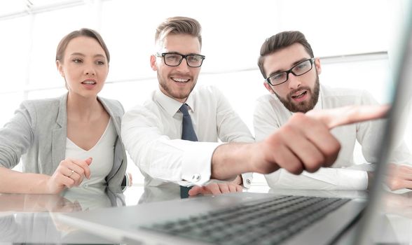 close up.smiling businessman pointing at laptop screen.business and technology