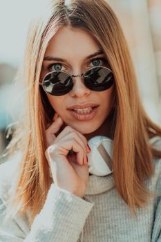 Close up of handsome young woman smiling while listening to music. 