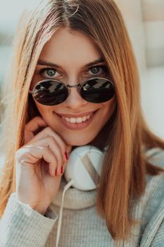 Close up of handsome young woman smiling while listening to music. 