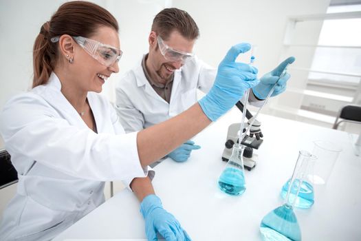 two scientists chemists conduct research in the laboratory.science and health