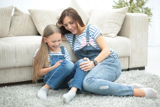 mother and her little daughter use a smartphone to view the photo.photo with copy space