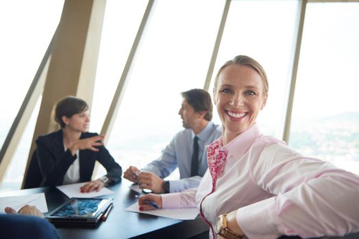 business woman on meeting, people group in background at modern bright office indoors