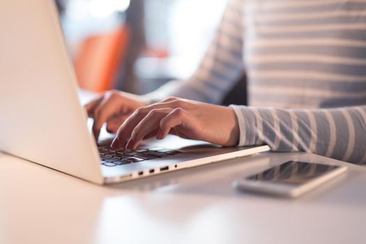 Young female Entrepreneur Freelancer Working Using A Laptop In Coworking space